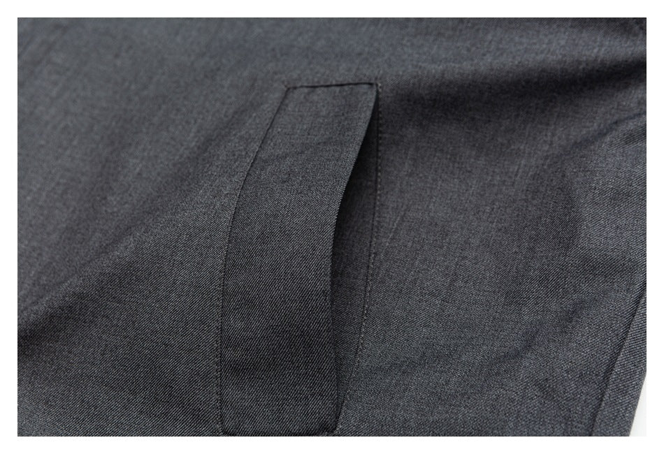 Close-up of a vertical welt pocket on the charcoal-gray jacket.