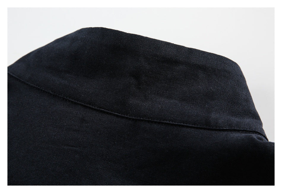 Close-up of black textured fabric with a curved stitched seam.