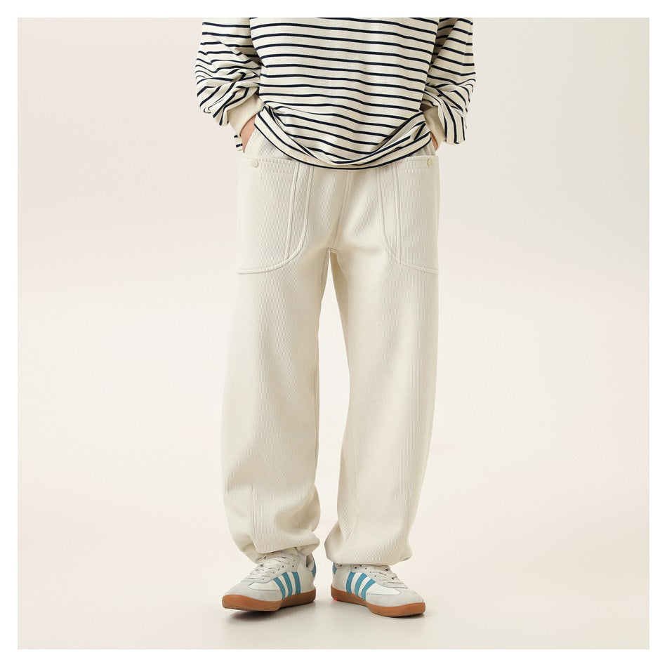 Model wearing ivory wide-leg pants with curved front patch pockets and a striped top, shown from waist to shoes.