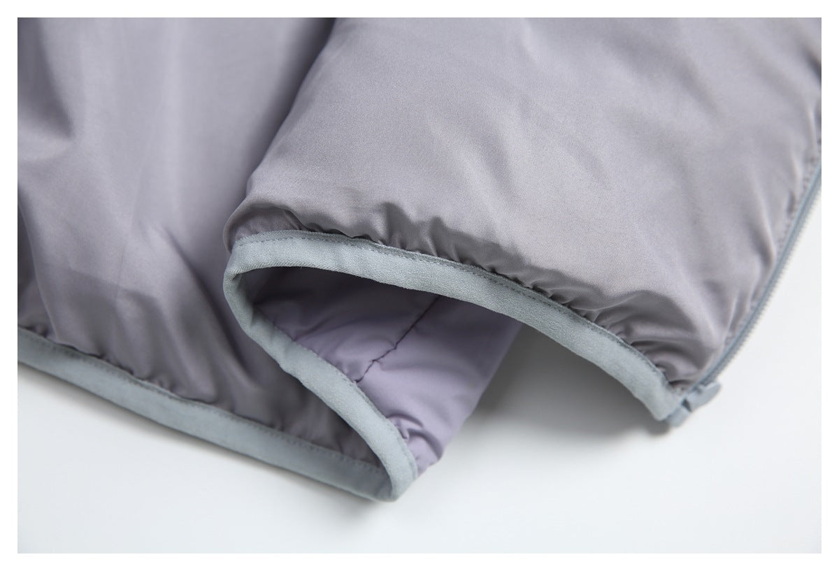 Close-up of a pale lavender-gray jacket edge with soft gray binding and a zipper.