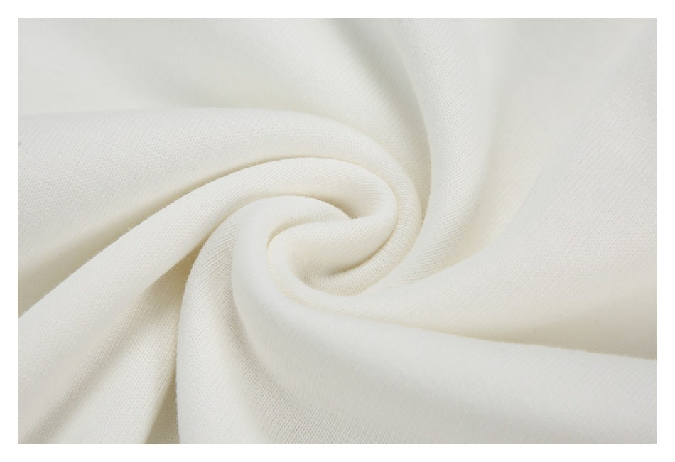 Close-up of off-white fabric gathered into a spiral, showing its fine knit texture.