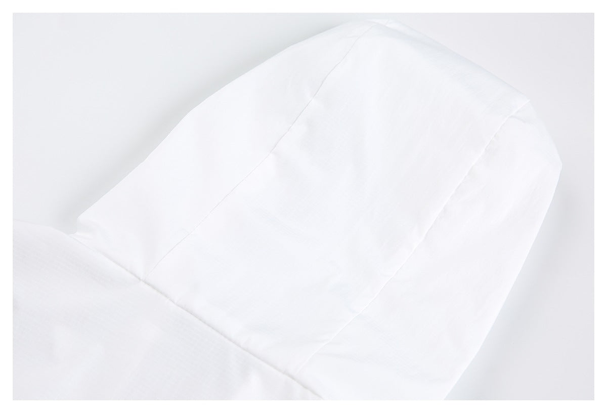 Close-up of white garment fabric showing curved panel seams.