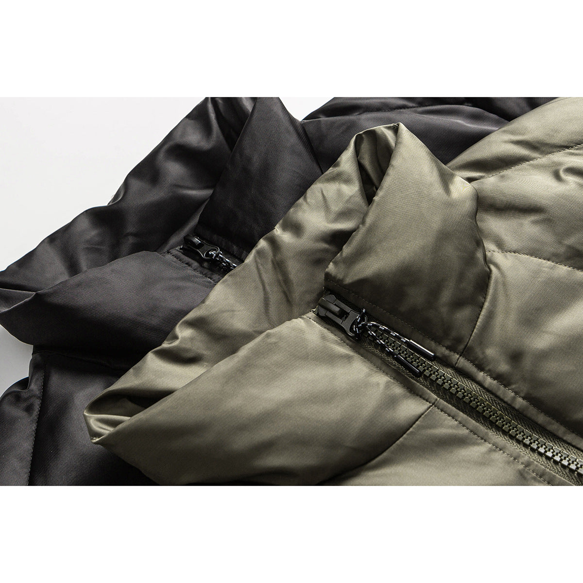 Close-up of black and olive jackets showing fabric panels and black zipper hardware.