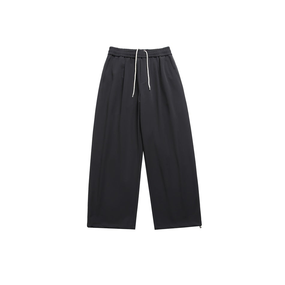 Dark charcoal wide-leg pants with white drawstring, elastic waist and hem toggles, flat lay front view