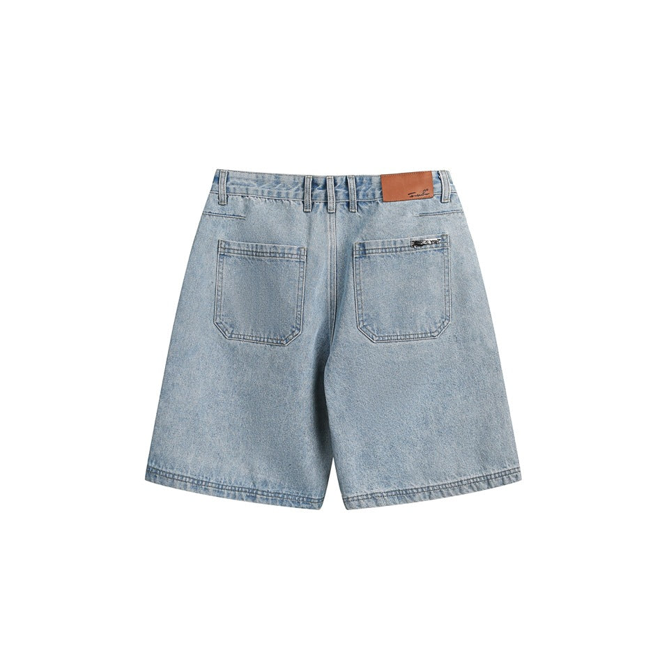 Back view of light blue denim shorts with two patch pockets, belt loops and a brown waistband patch.