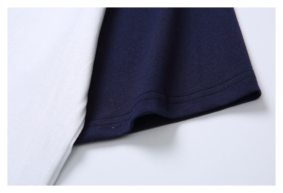 Close-up of a navy sleeve hem beside white shirt fabric, showing the stitching.