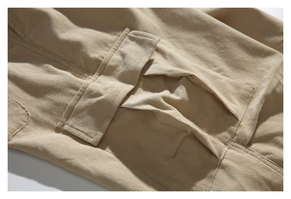 Close-up of beige pants showing a stitched belt loop and pocket seam.