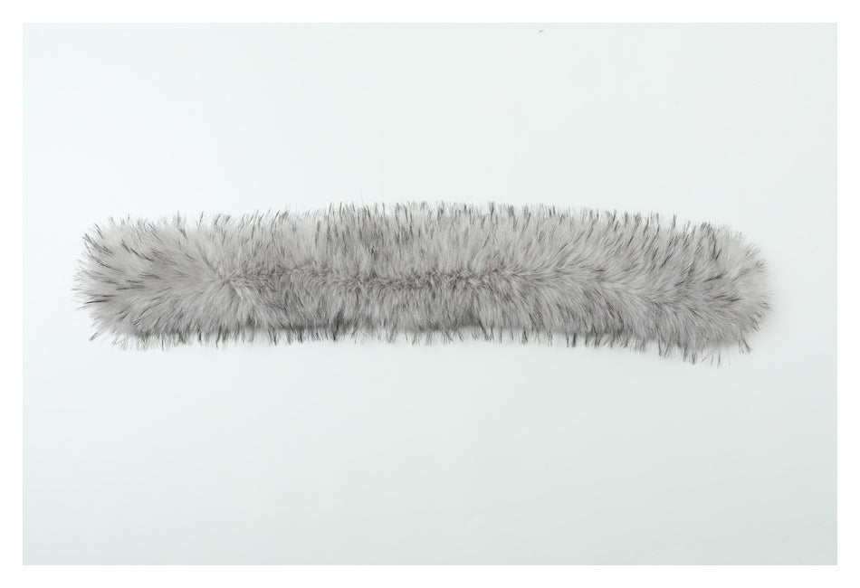 A long, light gray furry trim piece laid horizontally on a pale background.