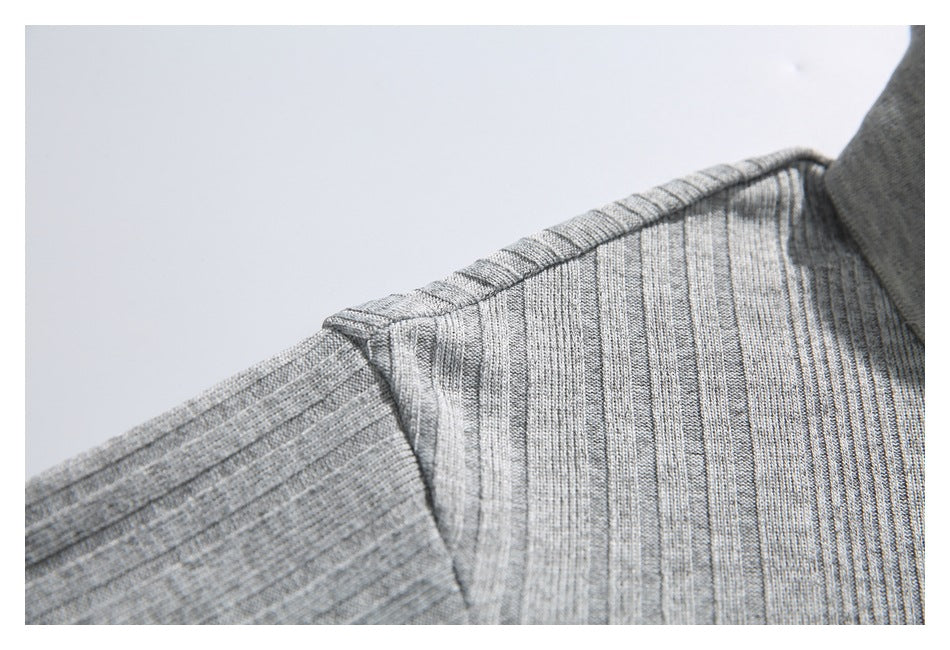 Close-up of the gray polo shirt's shoulder seam and ribbed knit.