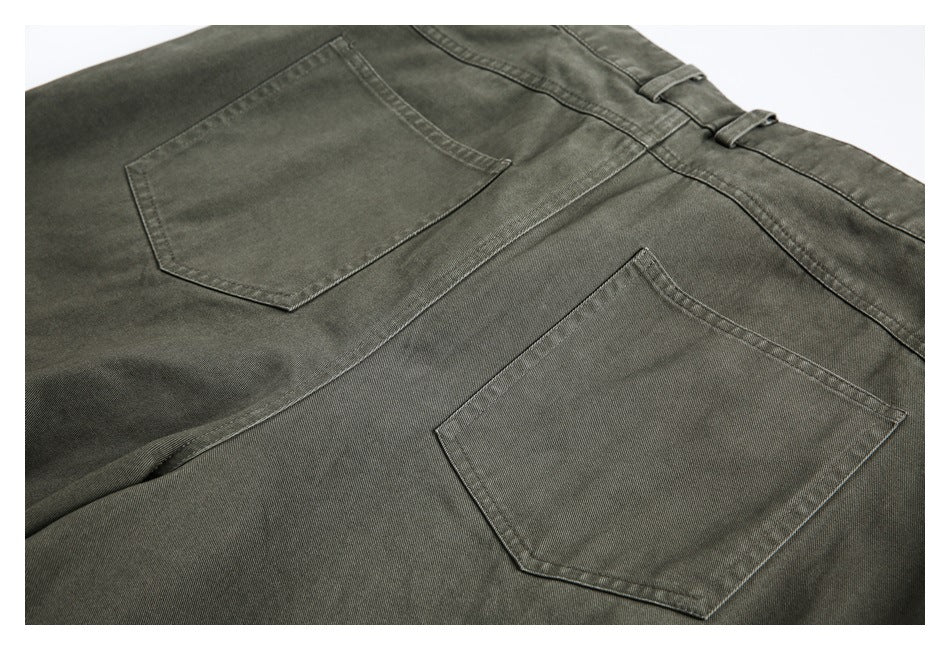 Close-up of olive-gray trousers showing two rear pockets and waistband loops.