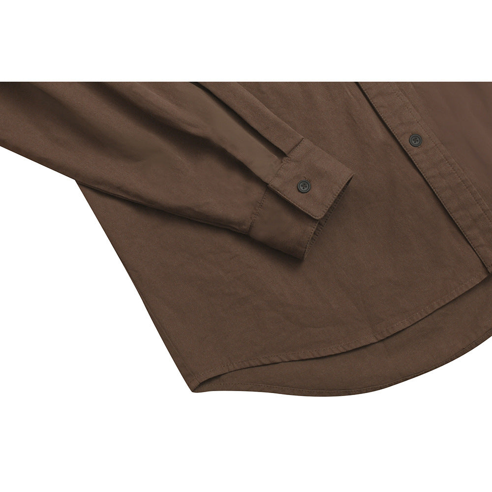 Close-up of a brown shirt sleeve and buttoned cuff, with part of the front placket and curved hem visible.