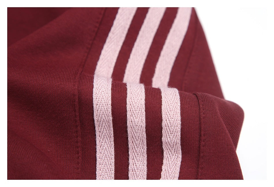 Close-up of pale stripes crossing the burgundy sleeve near a seam.