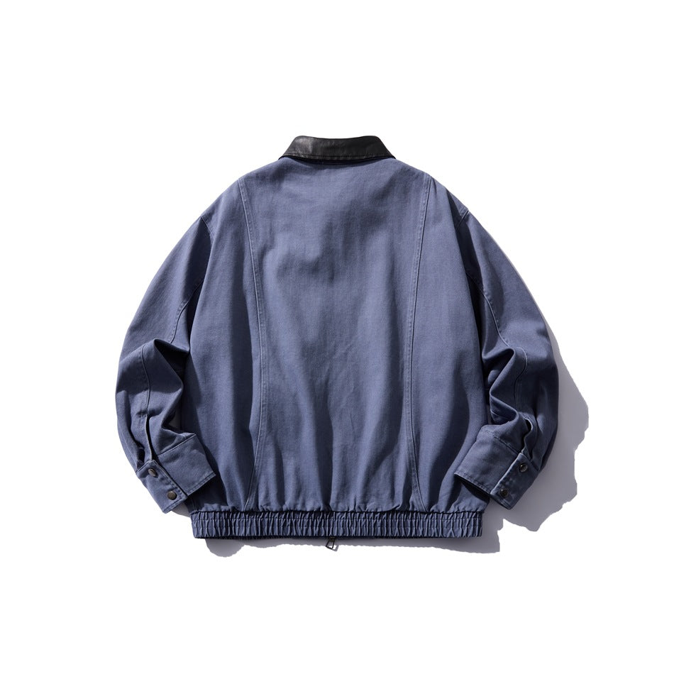 Washed blue jacket back view showing paneled seams, black collar, snap cuffs and elastic hem