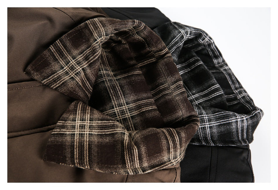 Close-up of brown and black jackets showing contrasting plaid collars and lining.