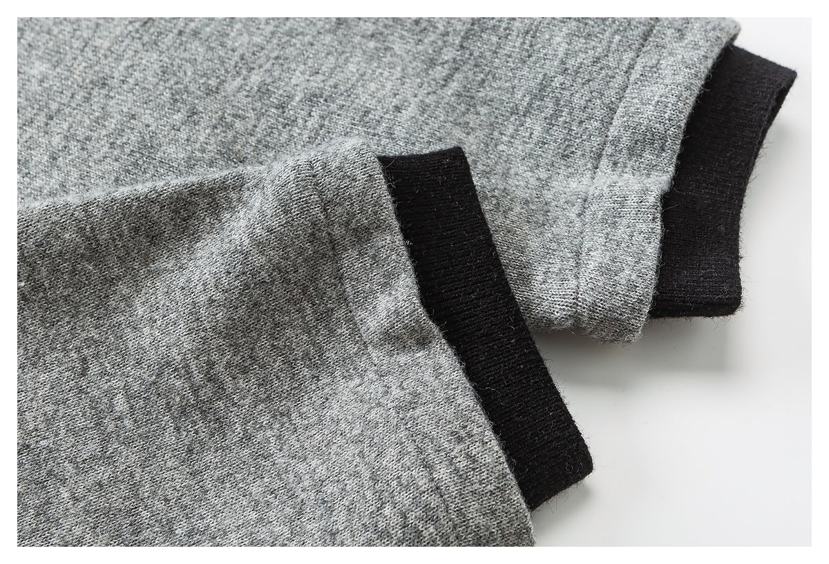Close-up of heather gray garment cuffs layered over black ribbed cuffs.