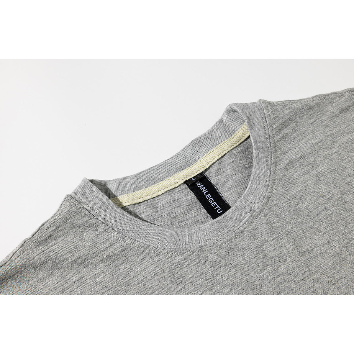 Close-up of a heather-gray T-shirt neckline and collar with a black neck label.