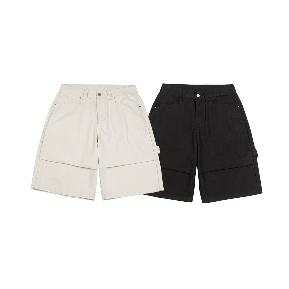 Front view of wide-leg utility shorts in cream and black, with belt loops, pockets and cargo details.