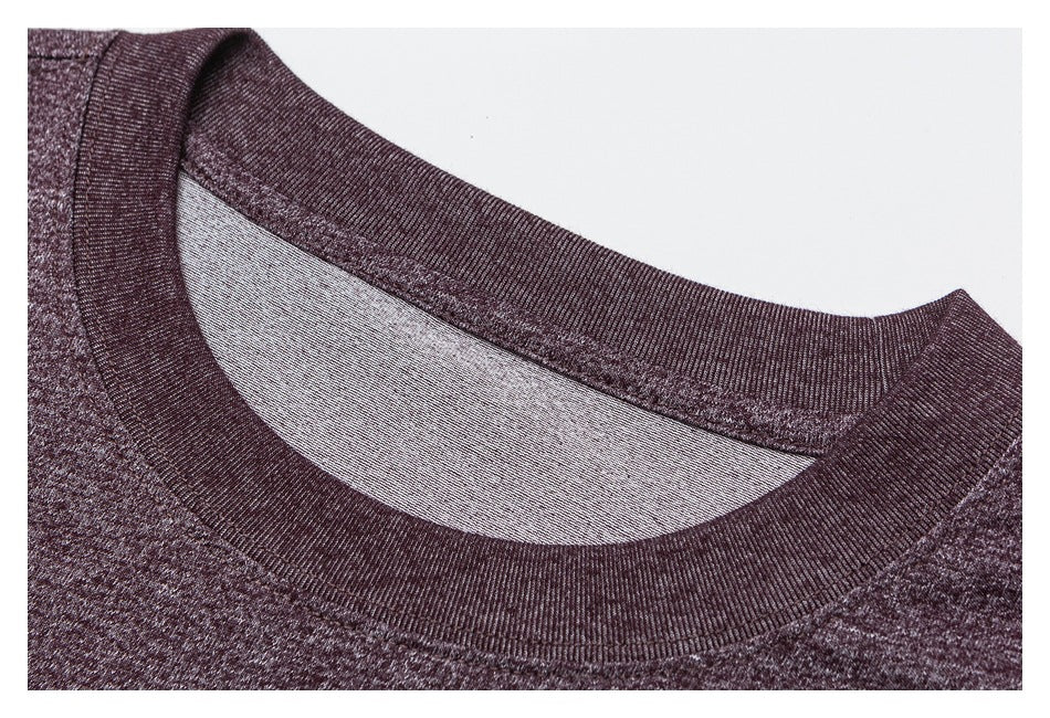 Close-up of a dark burgundy heathered shirt with a wide ribbed crew neckline.