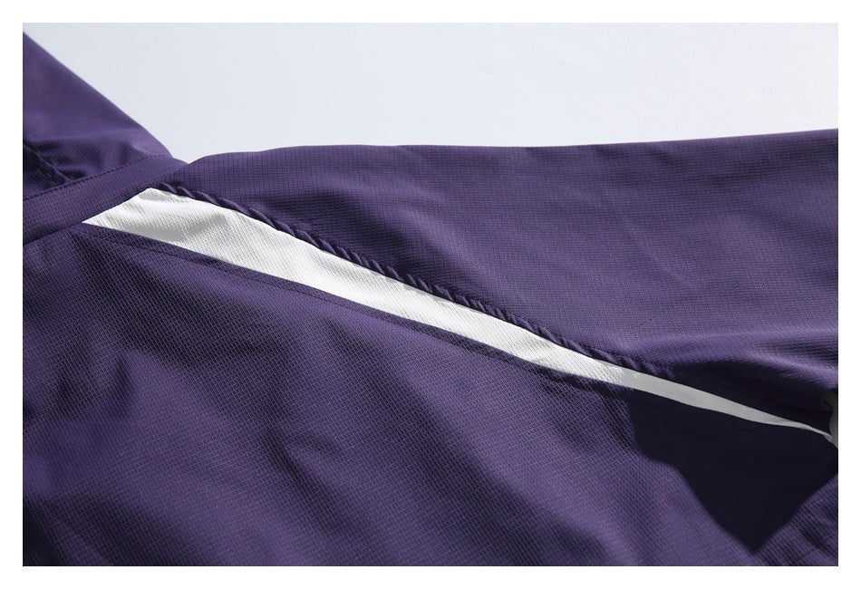Close-up of a white diagonal stripe across the textured purple jacket fabric.
