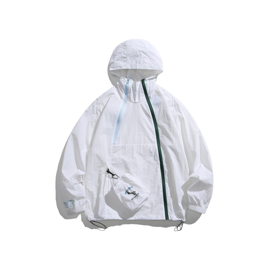 White hooded jacket with diagonal green and light blue zippers, drawcord hem and small drawstring pouch, flat lay