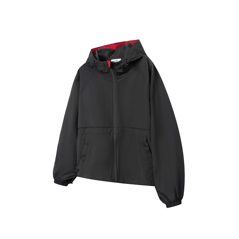 Black hooded zip-up jacket with red hood lining, front pockets and elastic cuffs, shown from a three-quarter front angle