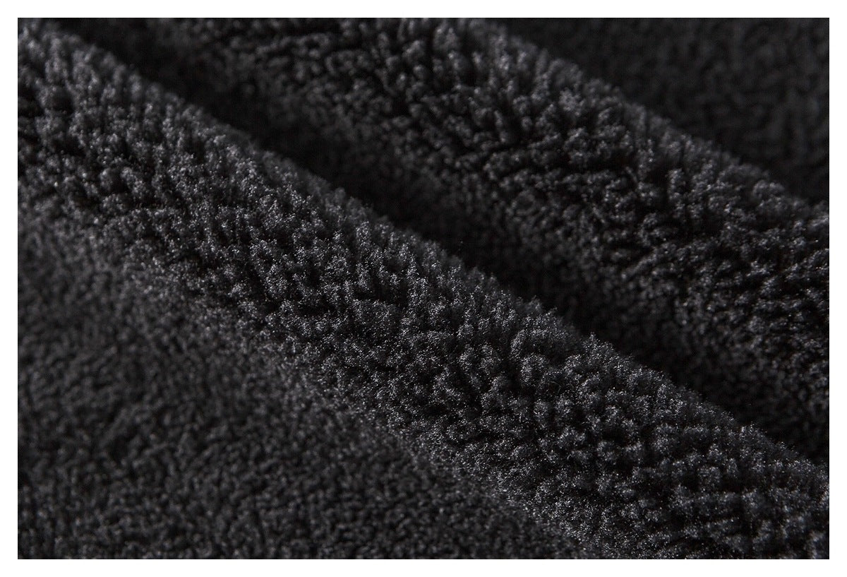 Macro view of a dark, fuzzy textured fabric surface.