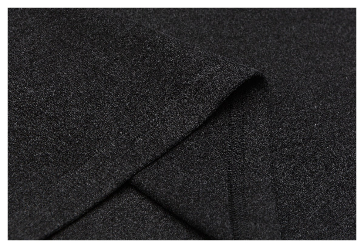 Close-up of dark charcoal fabric folded back to reveal an overlocked seam.