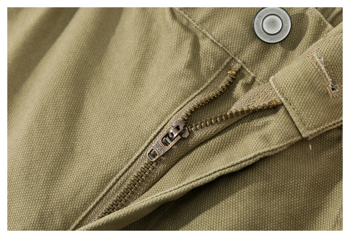 Close-up of the shorts’ metal button and partially open zipper fly.