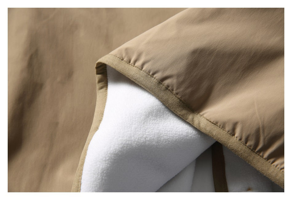 Close-up of the tan garment's bound edge, showing the white inner lining.