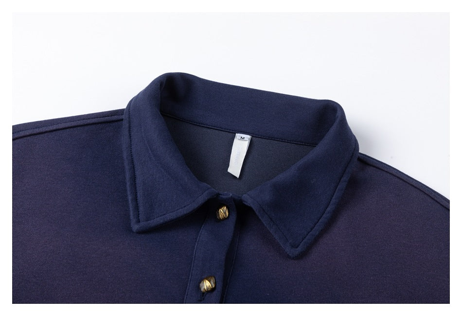 Close-up of the navy sweatshirt's pointed collar, two gold-tone buttons and neck label marked M.
