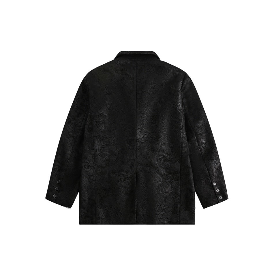 Back view of a black blazer with a tonal floral pattern, center seam, and three buttons at each cuff.