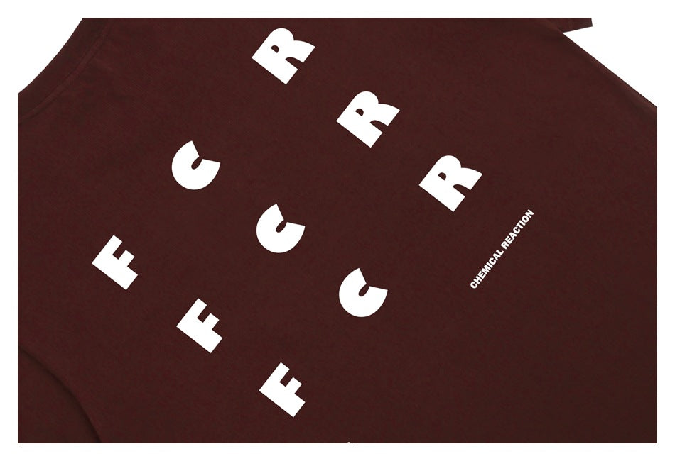 Close-up of white lettering printed on the dark brown T-shirt.
