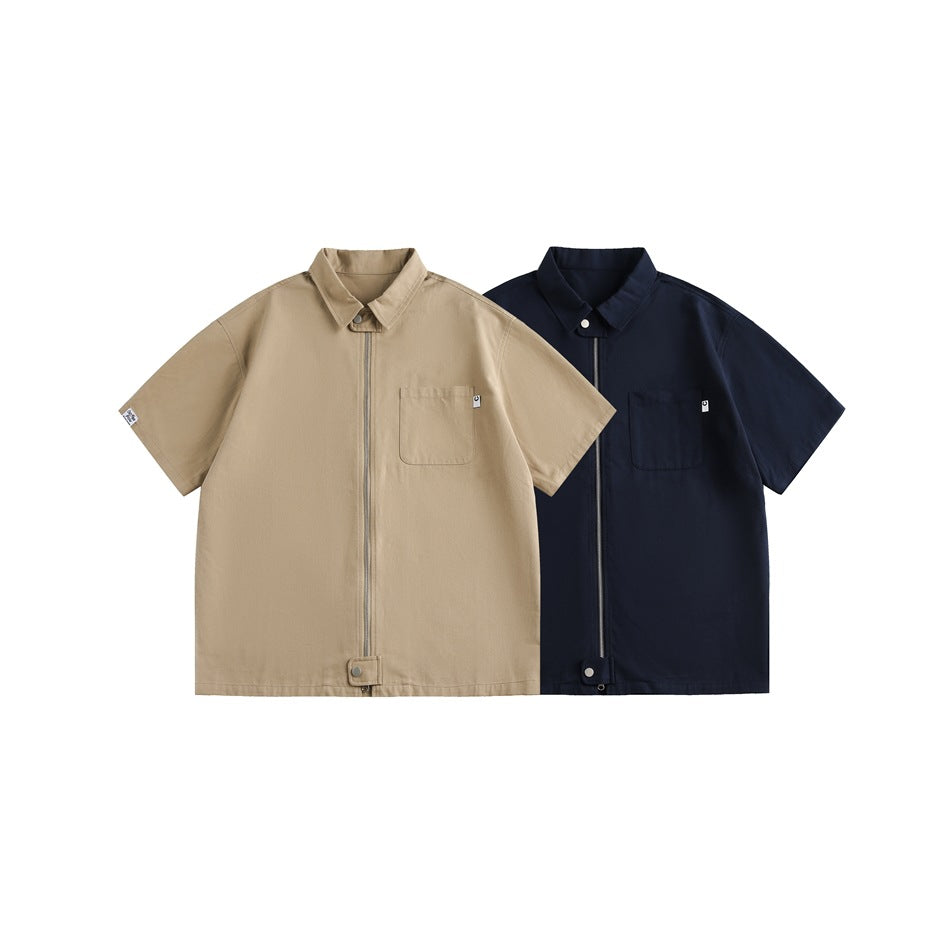 Two short-sleeve collared zip shirts shown together in tan and navy, each with a chest pocket.