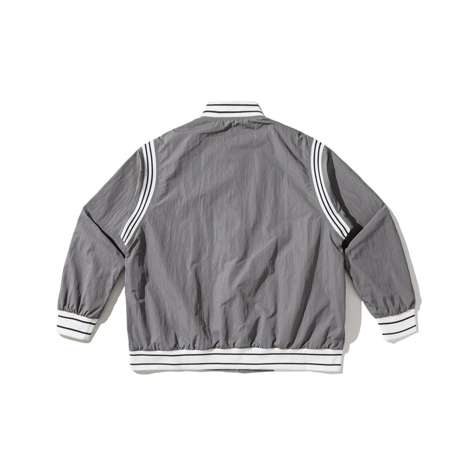 Back view of a gray jacket with white striped rib trim and curved white shoulder panels.