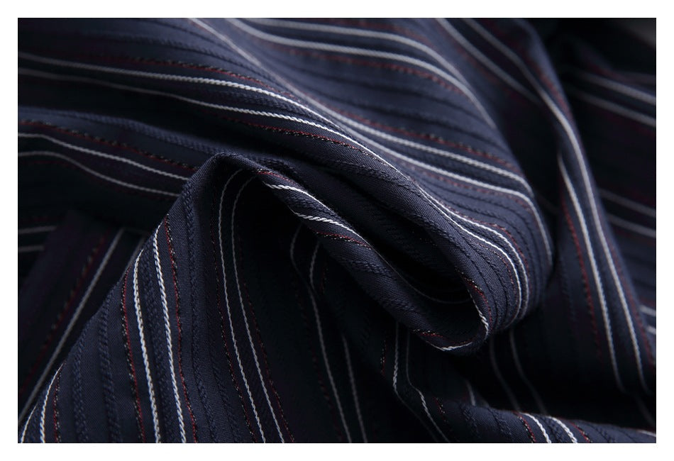 Macro view of dark navy striped fabric gathered into a soft fold.
