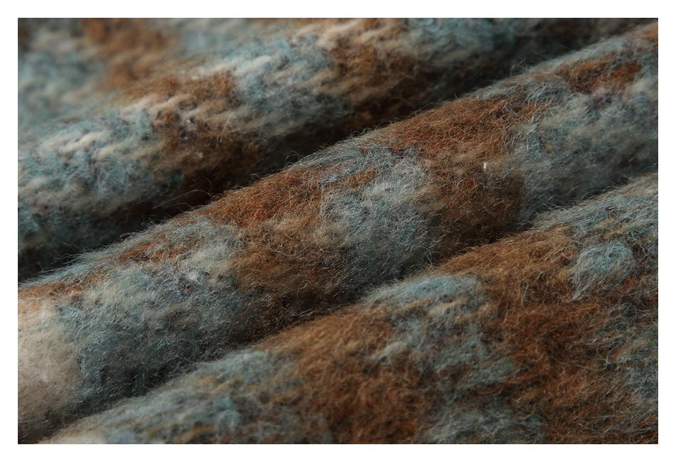 Extreme close-up of fuzzy plaid fabric in brown, blue-gray, and cream tones.