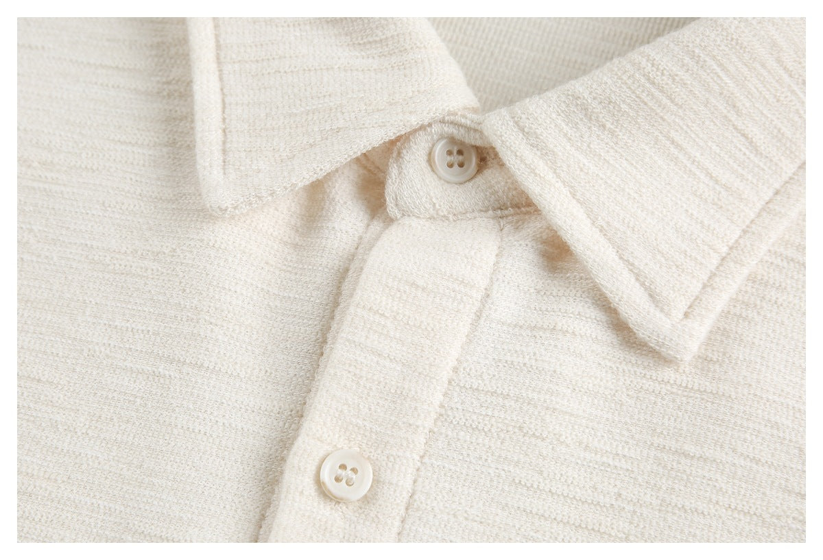 Close-up of an ivory textured collar, button placket and matching buttons.