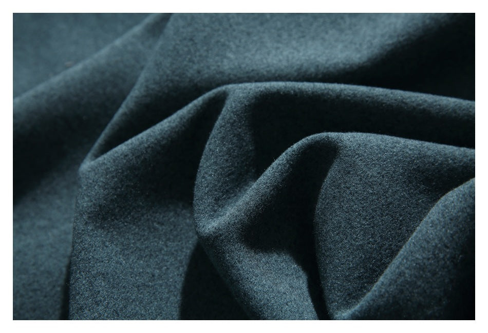 Close-up showing the soft, textured surface of dark teal fabric gathered into folds.