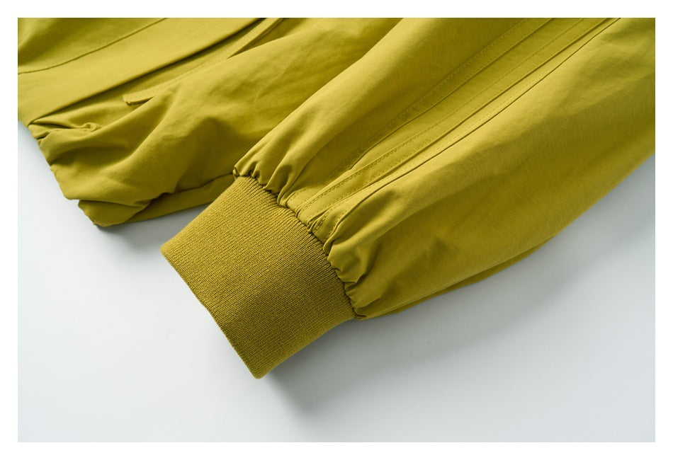 Mustard-yellow sleeve ending in a ribbed knit cuff.