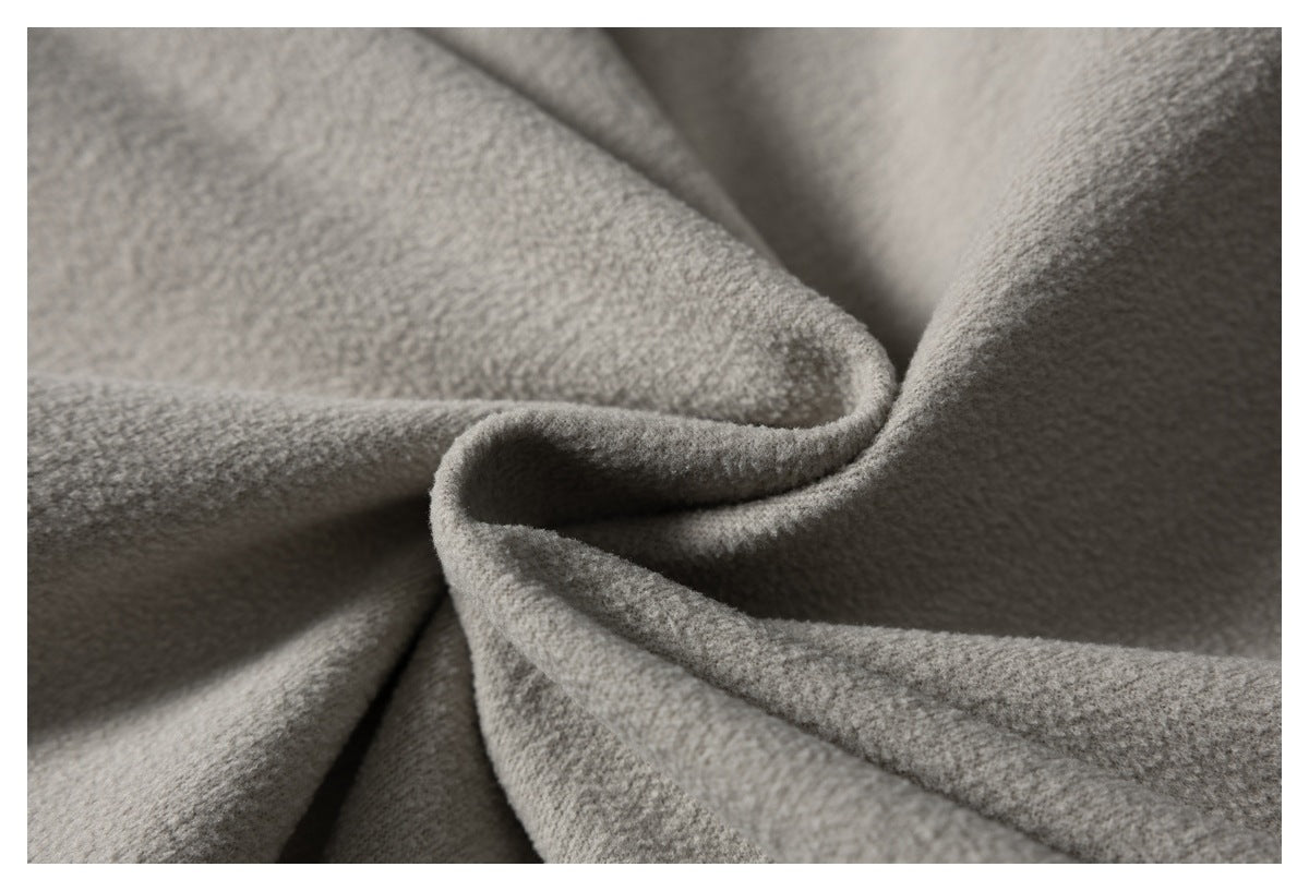 Extreme close-up of the soft, textured gray fleece fabric arranged in folds.