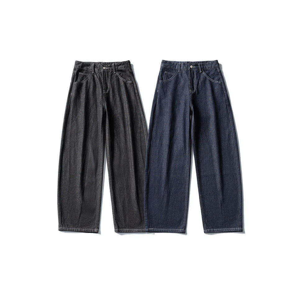 Two pairs of wide-leg jeans laid flat from the front, one charcoal black and one dark indigo.