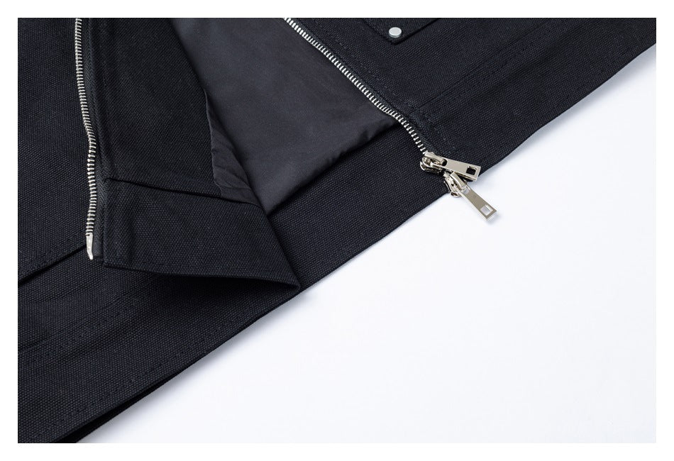 Close-up of the black jacket's partially open zipper, inner lining and lower edge.