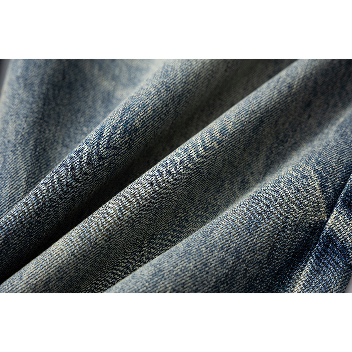 Macro view of the woven texture and faded finish of blue denim.