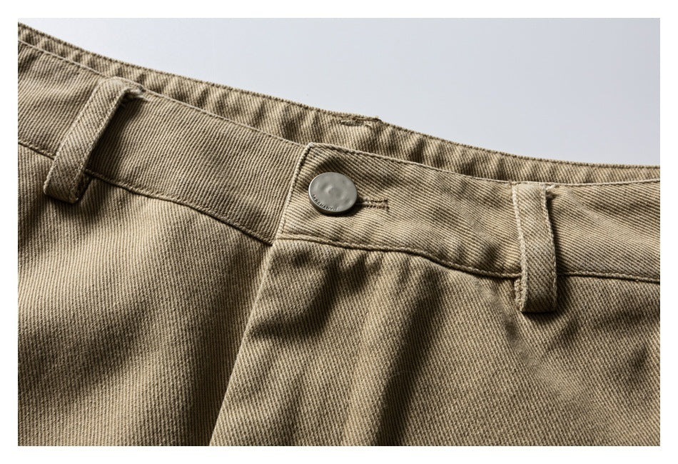 Close-up of the khaki trouser waistband, button and belt loops.