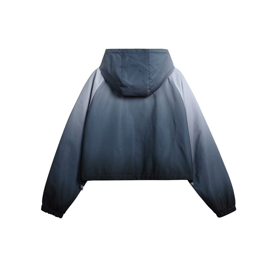 Back view of a cropped blue-gray gradient hooded jacket with a plain body and hood.