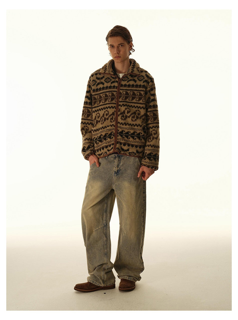 Man poses in a brown and black patterned zip-front fleece jacket with loose faded jeans, shown from the front.