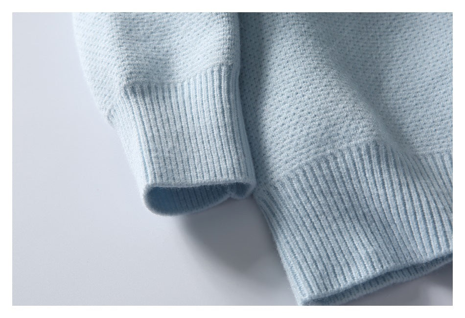 Close-up of the pale blue cardigan's ribbed cuff and hem with textured knit fabric.