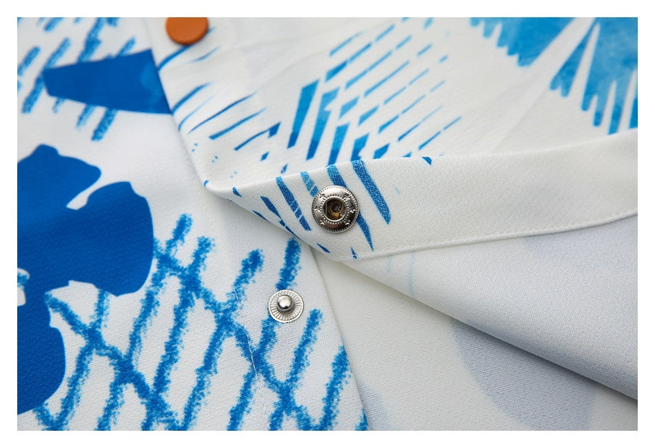 Close-up of a silver snap fastener on the blue-and-white printed shirt.
