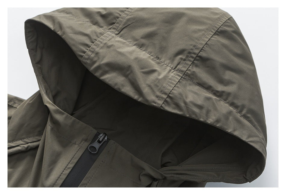 Close-up of the olive-gray jacket hood, showing its seams and black front zipper.