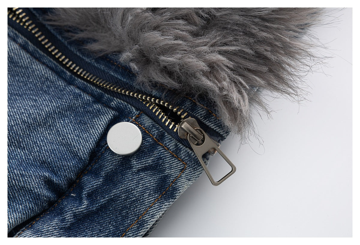 Close-up of the blue denim jacket's metal zipper, snap, and shaggy gray trim.